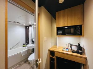 a bathroom with a toilet and a sink and a tub at Miru Kyoto Nishiki in Kyoto