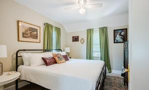 a bedroom with a bed with green curtains at Rachel's Private Hideaway with king bed, kitchen, laundry, parking and big yard in Toledo