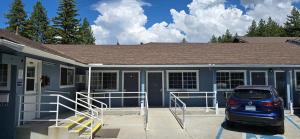 a car parked in front of a house at Bluebird Day Inn & Suites in South Lake Tahoe