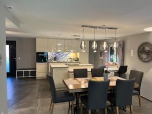 a dining room and kitchen with a table and chairs at Ferienhaus bis 6 Personen in Weißensberg