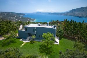 an aerial view of a house with a view of a lake at SeaSilia Luxury Villa in Korakiaí