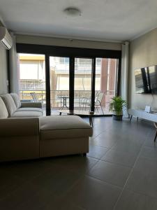 a living room with a couch and a table at SnappyB Living Spaces in Alexandroupoli