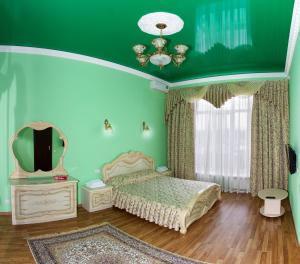 a bedroom with a bed and a mirror at Slavyanka Hotel in Krasnodar