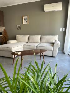 a living room with a couch and a coffee table at SnappyB Living Spaces in Alexandroupoli