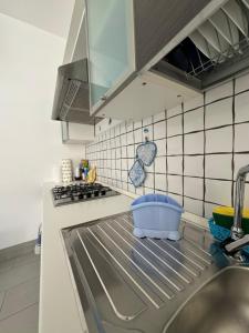 a kitchen with a sink and a counter top at Casa Vacanze Il Borghetto in Marzamemi