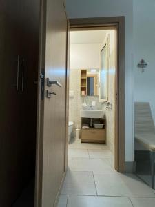 a bathroom with a toilet and a sink at Casa Vacanze Il Borghetto in Marzamemi +24 photos