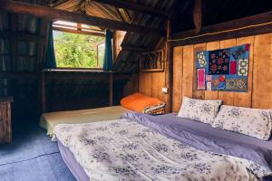 Postel nebo postele na pokoji v ubytování The Hermit Sapa Homestay + 18 fotografií