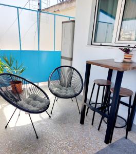 two chairs and a table on a balcony at Athens Centre Acropolis "Loft" apartment #516 in Athens
