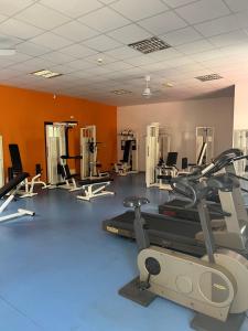 a gym with several treadmills and exercise machines at pizzo beach club in Fondaco Vecchio