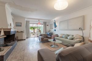 a living room with a couch and a fireplace at Villa de famille Maragre, au calme in Sainte-Marie-la-Mer