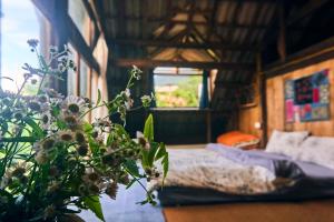 a bedroom with a bed and a window at The Hermit Sapa Homestay in Sa Pả