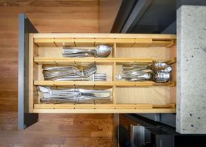 a cabinet with silver utensils in it at Enchanting Hidden Door Escape in Stoneham