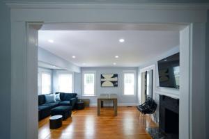 a living room with a couch and a table at Enchanting Hidden Door Escape in Stoneham