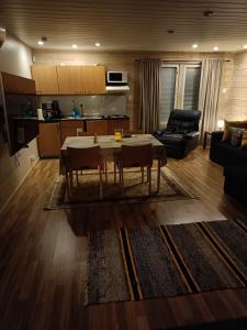 a living room with a table and a couch at Chalet Pellonranta 2 in Mäkituoma