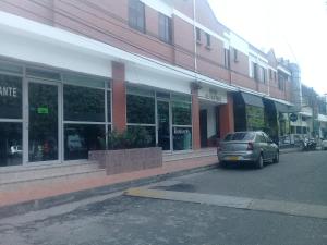 a car parked in a parking lot in front of a building at Hotel Frutas del Lago in Caucasia +18 photos