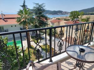 a balcony with a table and a view at Blue Bay Hotel in Iraklitsa