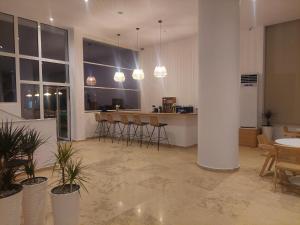 a large room with chairs and a bar with lights at Blue Bay Hotel in Iraklitsa +37 photos