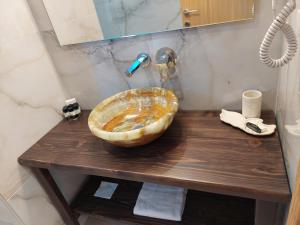a bathroom with a wooden sink on a wooden table at Blue Bay Hotel in Iraklitsa
