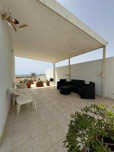a patio with a couch and chairs on a roof at Casa Vacanze Il Borghetto in Marzamemi
