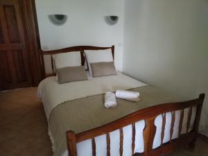 a bedroom with a bed with two towels on it at La petite Ginette in Serres
