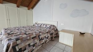 a bedroom with a bed and a desk in it at Welcome to Ossola in Trontano