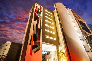 a building with a painting on the side of it at Hennessy Park Hotel in Ebene