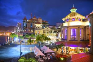 a view of a city at night with a building at Labourdonnais Waterfront Hotel in Port Louis