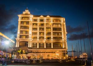 a large white building with lights on at Labourdonnais Waterfront Hotel in Port Louis