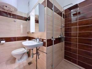 a bathroom with a toilet and a sink and a shower at APP St Marin view Novi Vinodolski in Novi Vinodolski