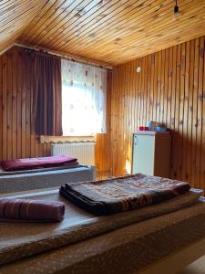 a bedroom with two beds in a wooden room at Verica Rooms in Žabljak +16 photos