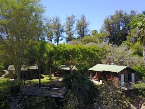 a log cabin in the woods with trees at Avoca River Cabins in Addo
