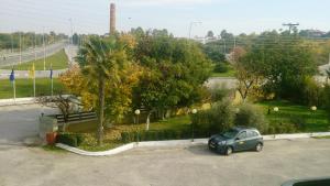 a small car parked in a parking lot at Hotel Villa Tasko in Drama