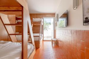 a small room with bunk beds and a window at Villa St Remy Centre Piscine chauffée et Hammam in Saint-Rémy-de-Provence +78 photos