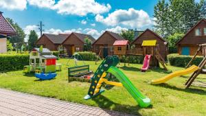 a playground with a bunch of play equipment in a yard at Ośrodek Wypoczynkowy Klub Mazurski in Ruciane-Nida