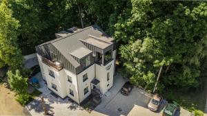 an overhead view of a white building with trees at Riverra House - Studio Panorama View in Kaunas