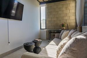 ein Wohnzimmer mit Couch und Flachbildfernseher in der Unterkunft Casa KiKi Penthouse by Beach and Town in San José del Cabo