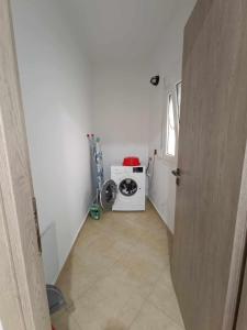 a hallway with a washing machine in a room at Giannis's Apartments in Chios