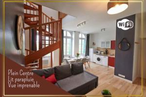 un salon avec un canapé et un escalier en colimaçon dans l'établissement L'Éclat Travot Central Lumineux Vue Sublime, à Cholet