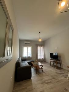 a living room with a couch and a table at Χαβίνη 35 in Amfilochía