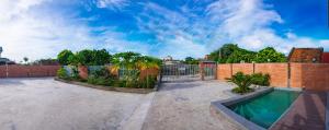 a backyard with a brick fence and a swimming pool at CRIN HOUSE Đồng Châu in Lạc Thành