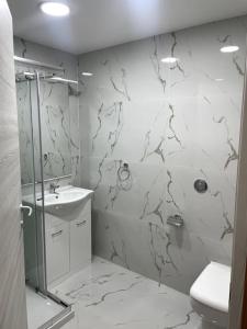 a bathroom with a shower and a toilet and a sink at Floriana Cosy Corner in Il-Furjana +10 photos