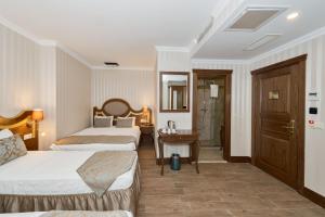 A bed or beds in a room at The Central Hotel