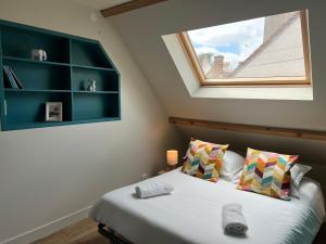 a bedroom with a large bed with a window at Les Quatre Saisons de Chambord in Maslives +21 photos