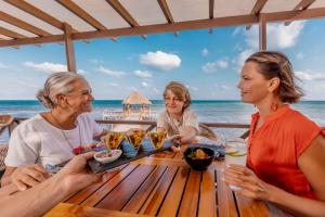 a group of women sitting at a table on the beach at Hyatt Ziva Riviera Cancun All-Inclusive in Puerto Morelos