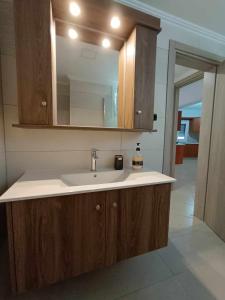 a bathroom with a sink and a mirror at Giannis's Apartments in Chios
