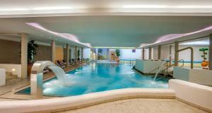 a swimming pool in a hotel with a slide at Ferienhaus am Hammersbach in Grainau