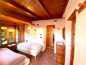 a bedroom with two beds and a wooden ceiling at Finca Tenerife - Authentisches kanarisches Haus mit Traumblick und tropischem Garten in Icod de los Vinos +25 photos