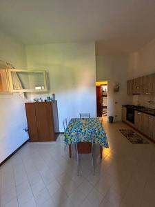 a kitchen with a table with a table cloth on it at Casa vacanza La Sciumara in Palau