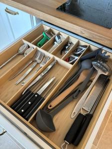 a drawer full of kitchen utensils in a cabinet at Studio centre ville- Grand balcon-Meublé BoConcept in Cavalaire-sur-Mer