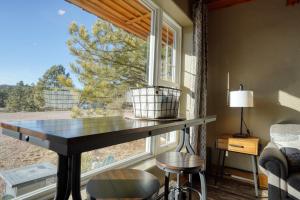 a table in front of a window in a room at Ponderosa Cabin at Highland Meadows in Hot Springs